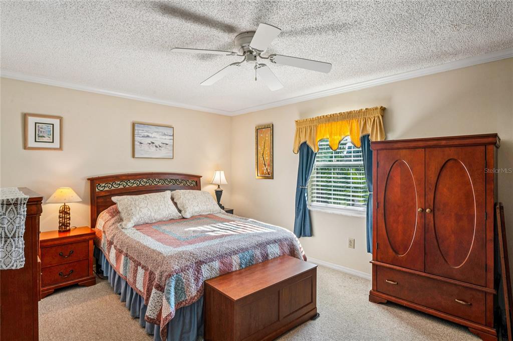 6709 Timbercove Lane, Unit 6709 New Port Richey, FL 34653 - Photo 18 of 52 a bedroom with a bed and dresser with wooden floor