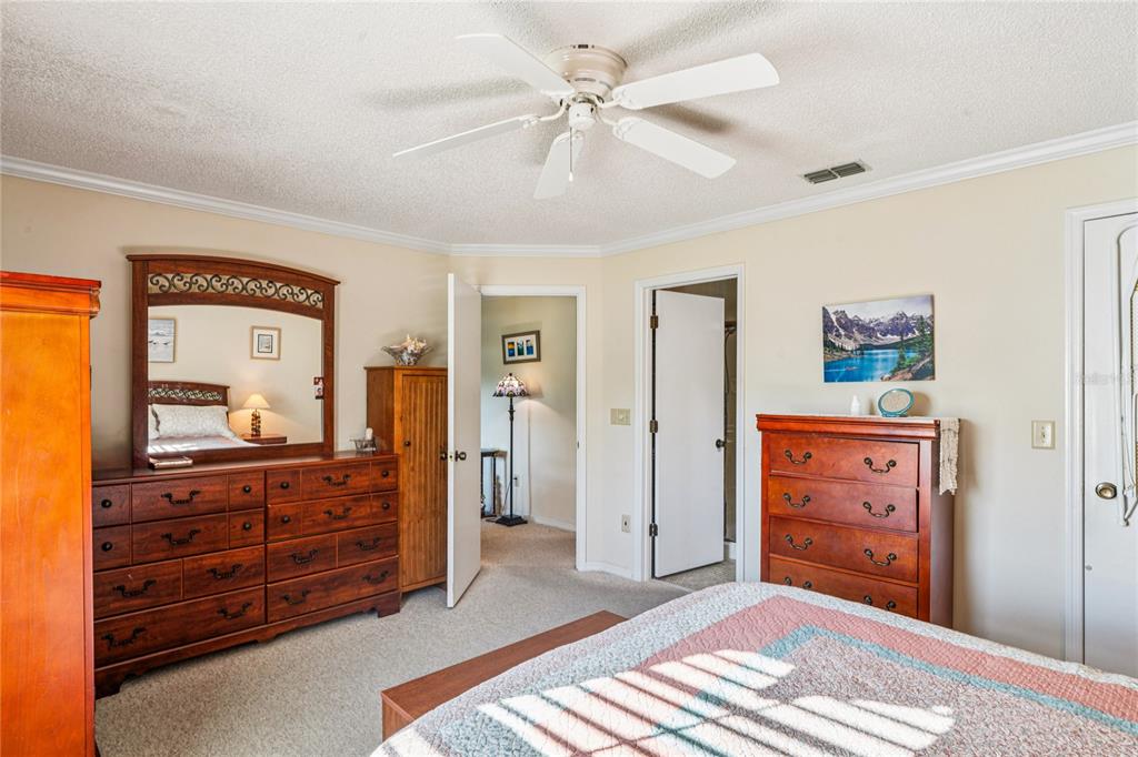 6709 Timbercove Lane, Unit 6709 New Port Richey, FL 34653 - Photo 20 of 52 a bedroom with a bed and a dresser in it