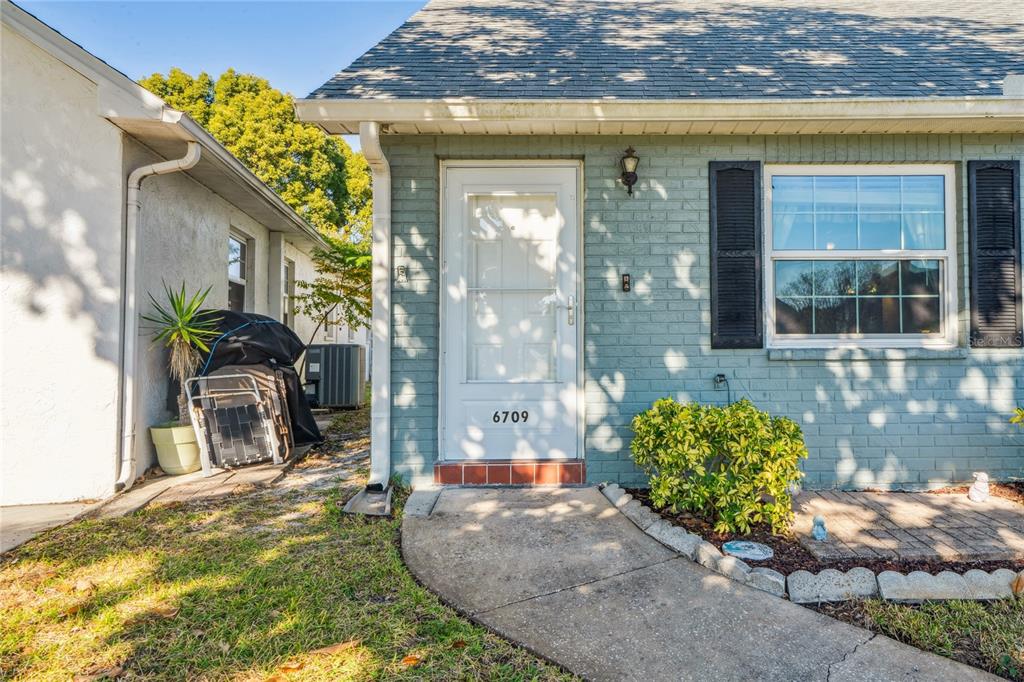 6709 Timbercove Lane, Unit 6709 New Port Richey, FL 34653 - Photo 2 of 52 a view of a entryway front of house