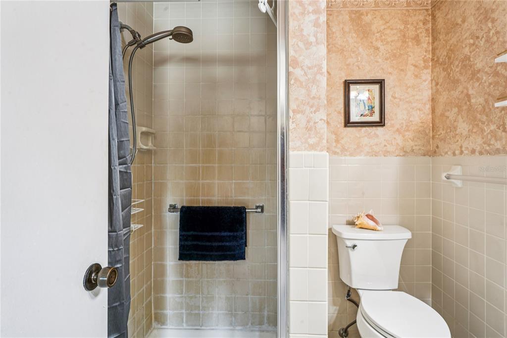 6709 Timbercove Lane, Unit 6709 New Port Richey, FL 34653 - Photo 22 of 52 a bathroom with a toilet and a shower
