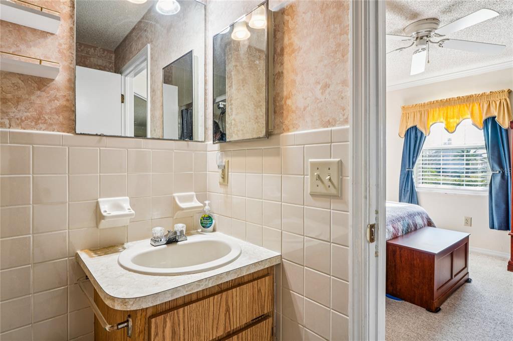 6709 Timbercove Lane, Unit 6709 New Port Richey, FL 34653 - Photo 23 of 52 a bathroom with a sink a toilet and a mirror