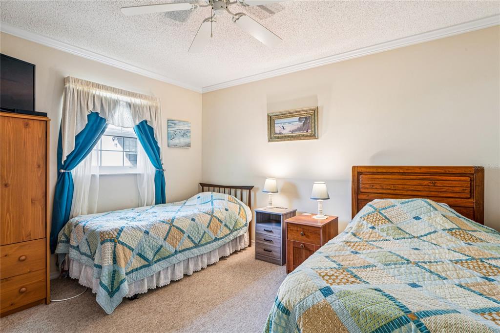 6709 Timbercove Lane, Unit 6709 New Port Richey, FL 34653 - Photo 24 of 52 a bedroom with 2 bed and a window