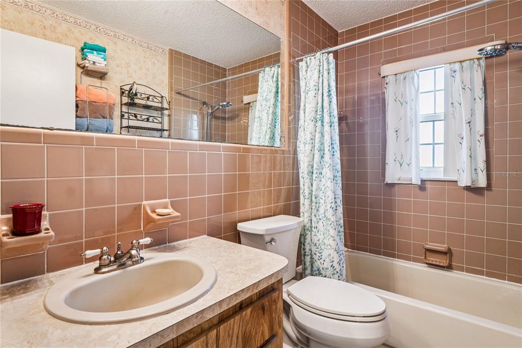 6709 Timbercove Lane, Unit 6709 New Port Richey, FL 34653 - Photo 26 of 52 a bathroom with a sink toilet and shower