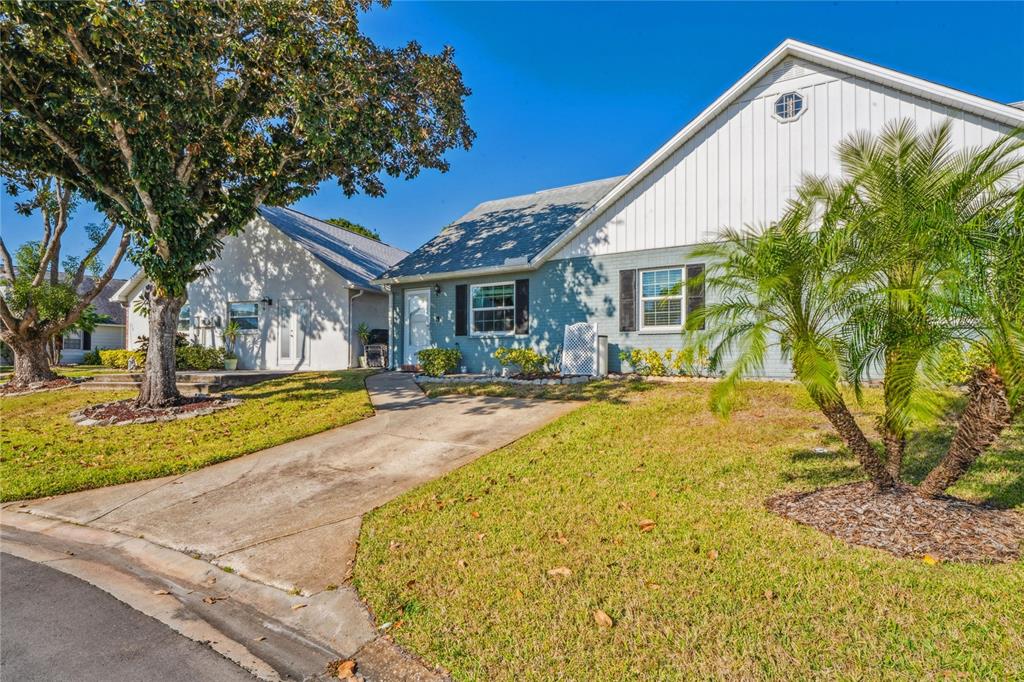 6709 Timbercove Lane, Unit 6709 New Port Richey, FL 34653 - Photo 29 of 52 a swimming pool with outdoor seating and yard