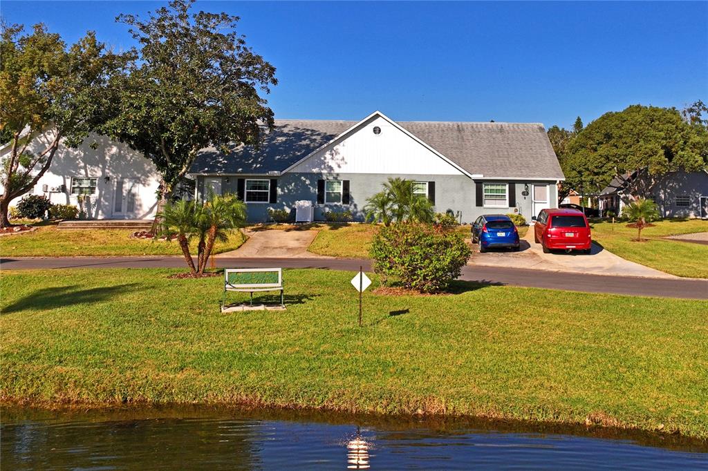 6709 Timbercove Lane, Unit 6709 New Port Richey, FL 34653 - Photo 34 of 52 a front view of a house with garden