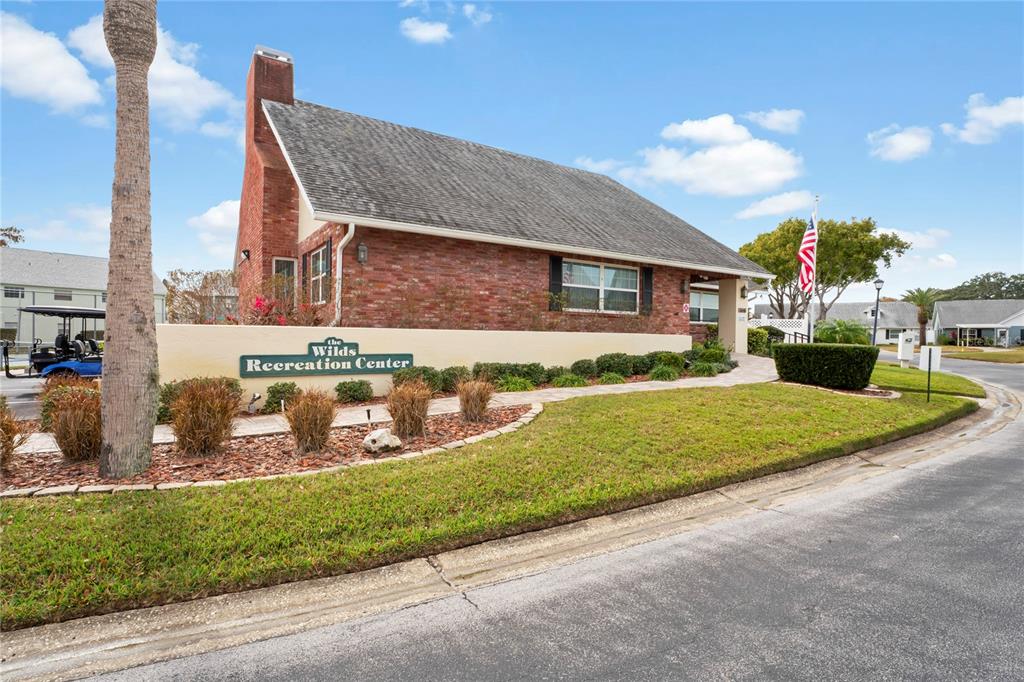 6709 Timbercove Lane, Unit 6709 New Port Richey, FL 34653 - Photo 35 of 52 a front view of a house with a garden and yard