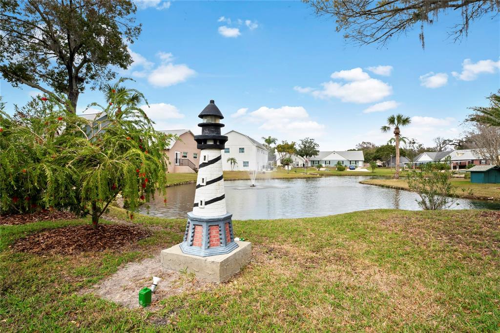 6709 Timbercove Lane, Unit 6709 New Port Richey, FL 34653 - Photo 40 of 52 a swimming pool with trees in the background