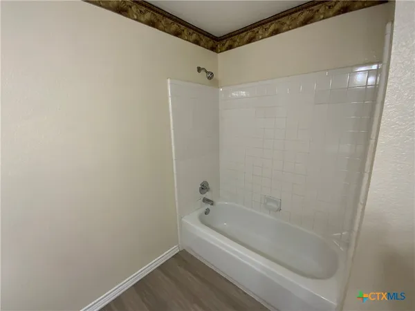 a bathroom with a tub and shower