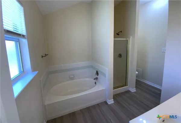 a white bath tub sitting next to a white sink
