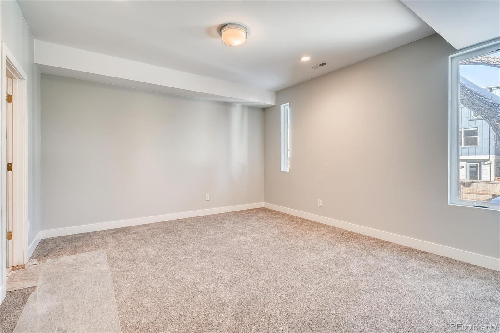 1237 Perry Street Denver, CO 80204 - Photo 11 of 37 an empty room with windows