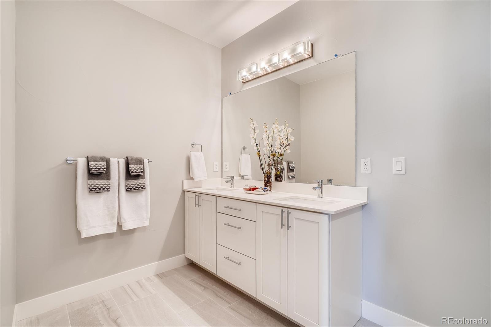 1237 Perry Street Denver, CO 80204 - Photo 13 of 37 a bathroom with a sink a vanity and a mirror