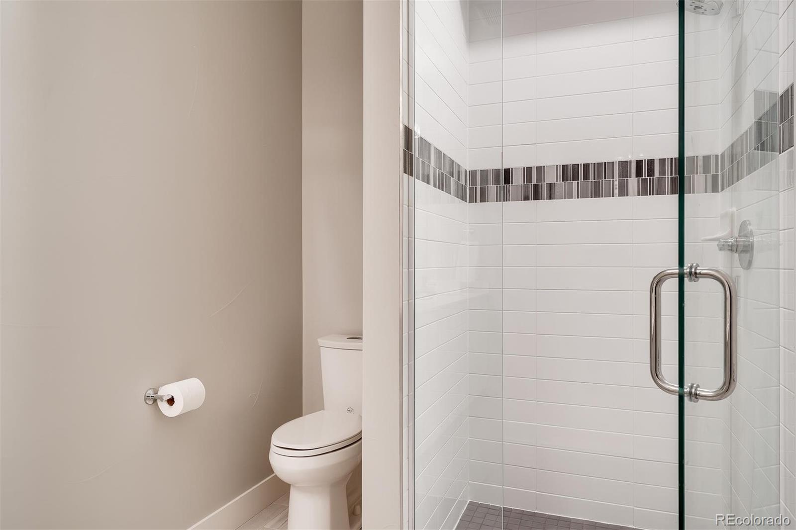 1237 Perry Street Denver, CO 80204 - Photo 14 of 37 a bathroom with a toilet and a shower