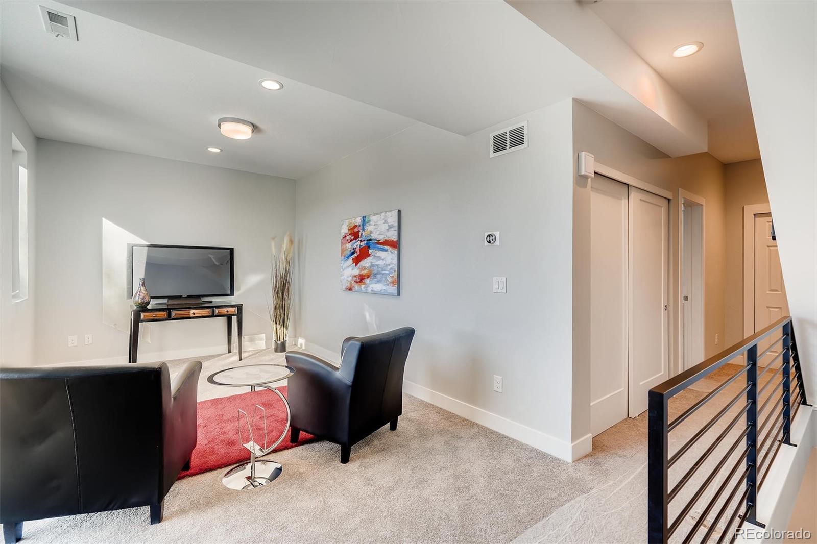 1237 Perry Street Denver, CO 80204 - Photo 16 of 37 a living room with furniture and a flat screen tv