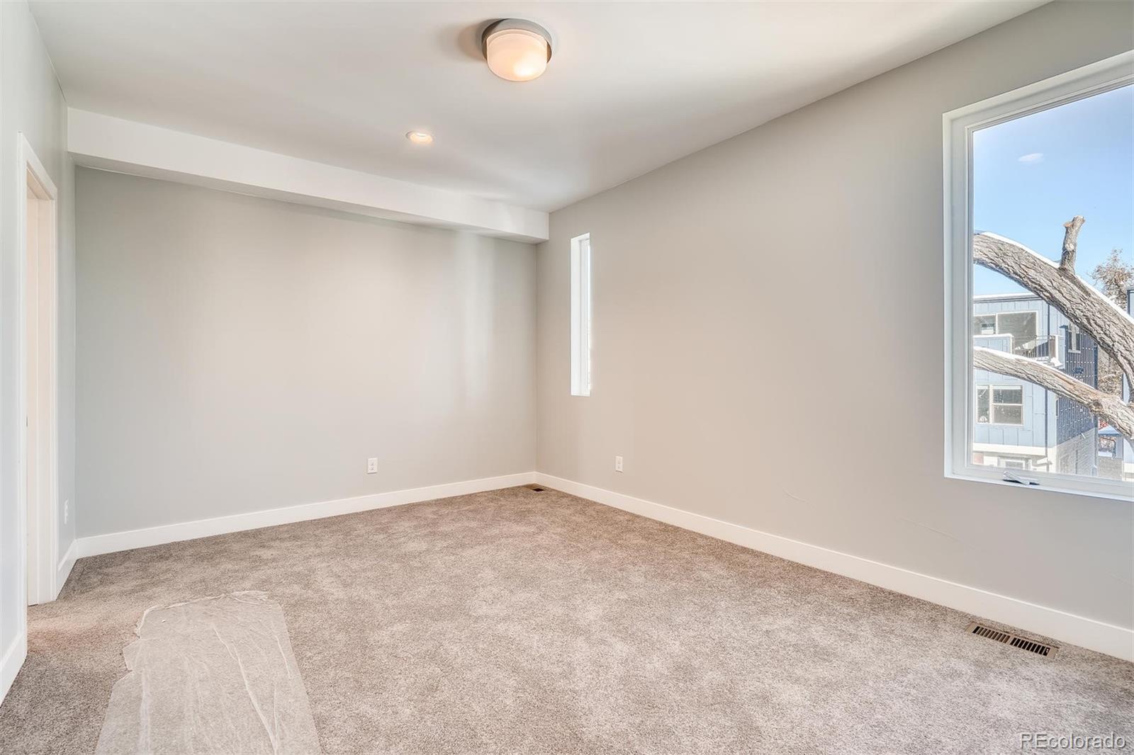 1237 Perry Street Denver, CO 80204 - Photo 17 of 37 an empty room with windows