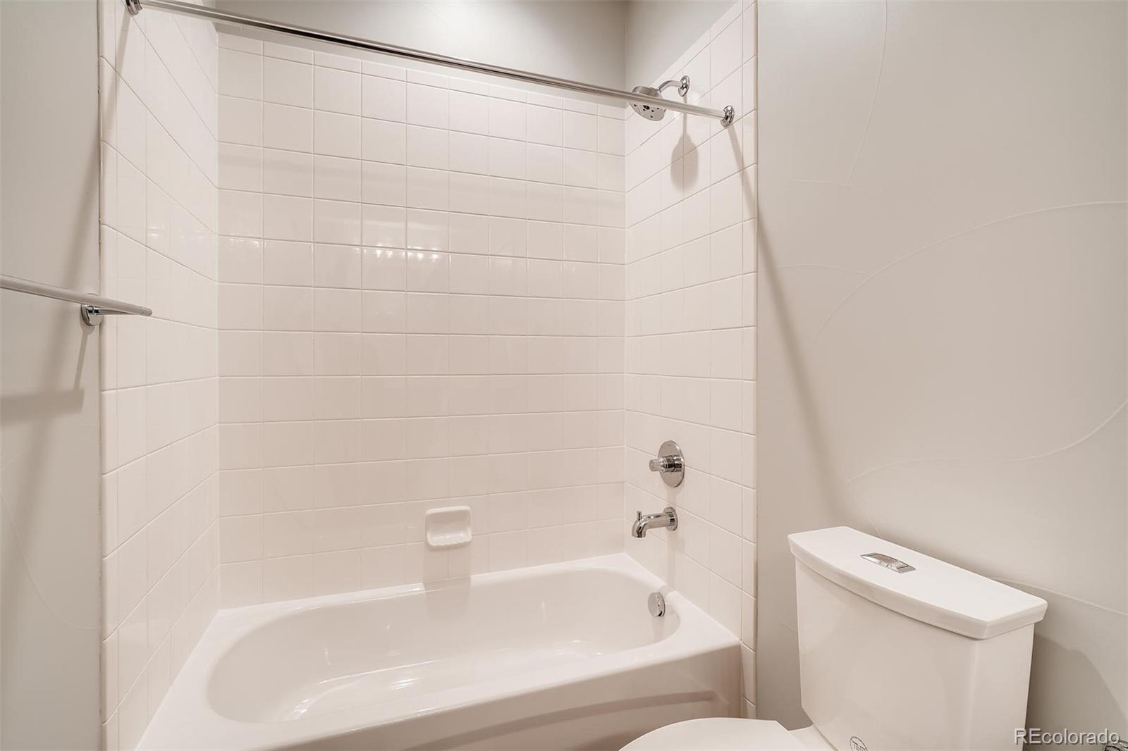 1237 Perry Street Denver, CO 80204 - Photo 22 of 37 a bathroom with a white bath tub and a shower