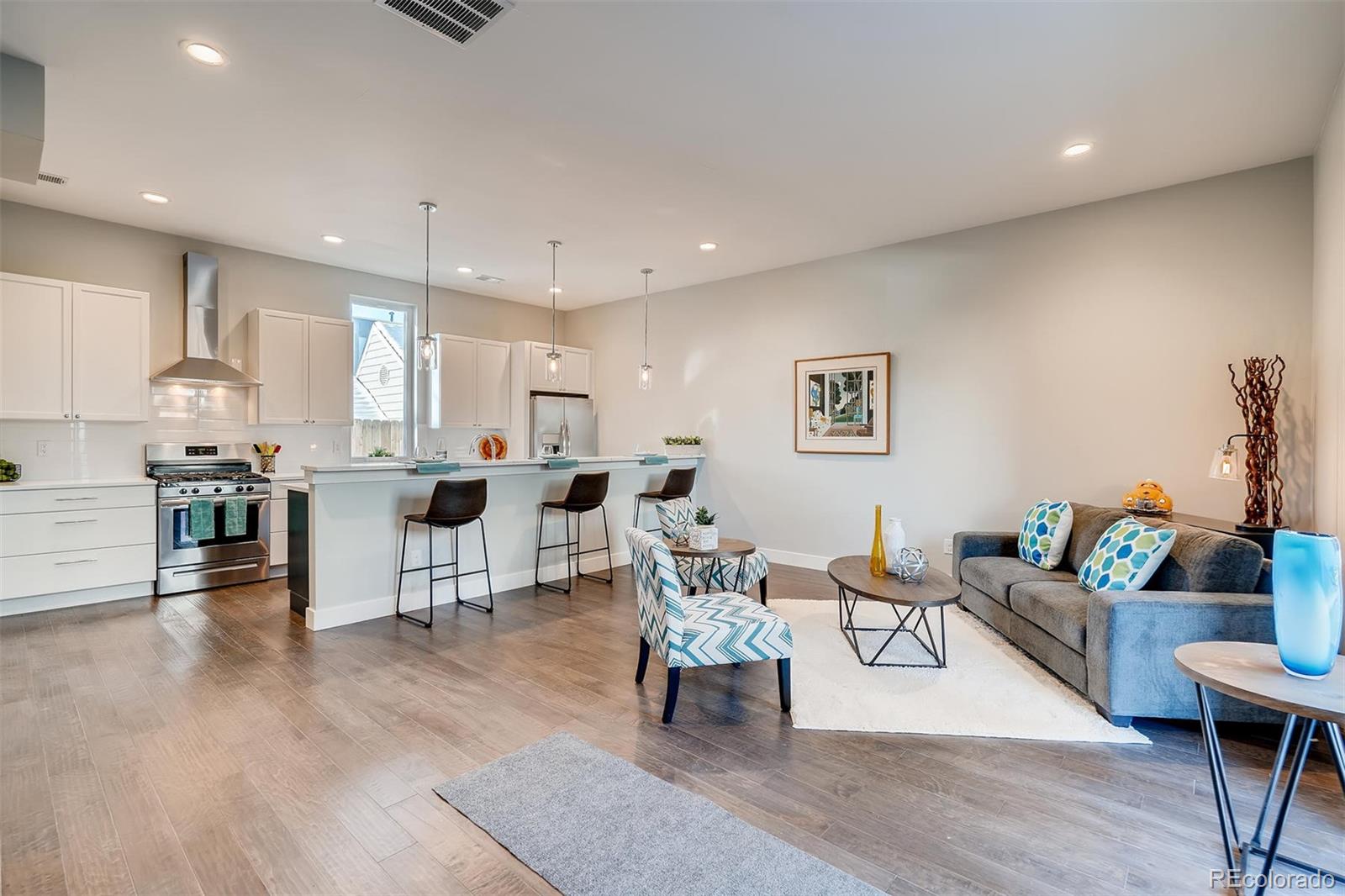 1237 Perry Street Denver, CO 80204 - Photo 4 of 37 a living room with furniture and kitchen view