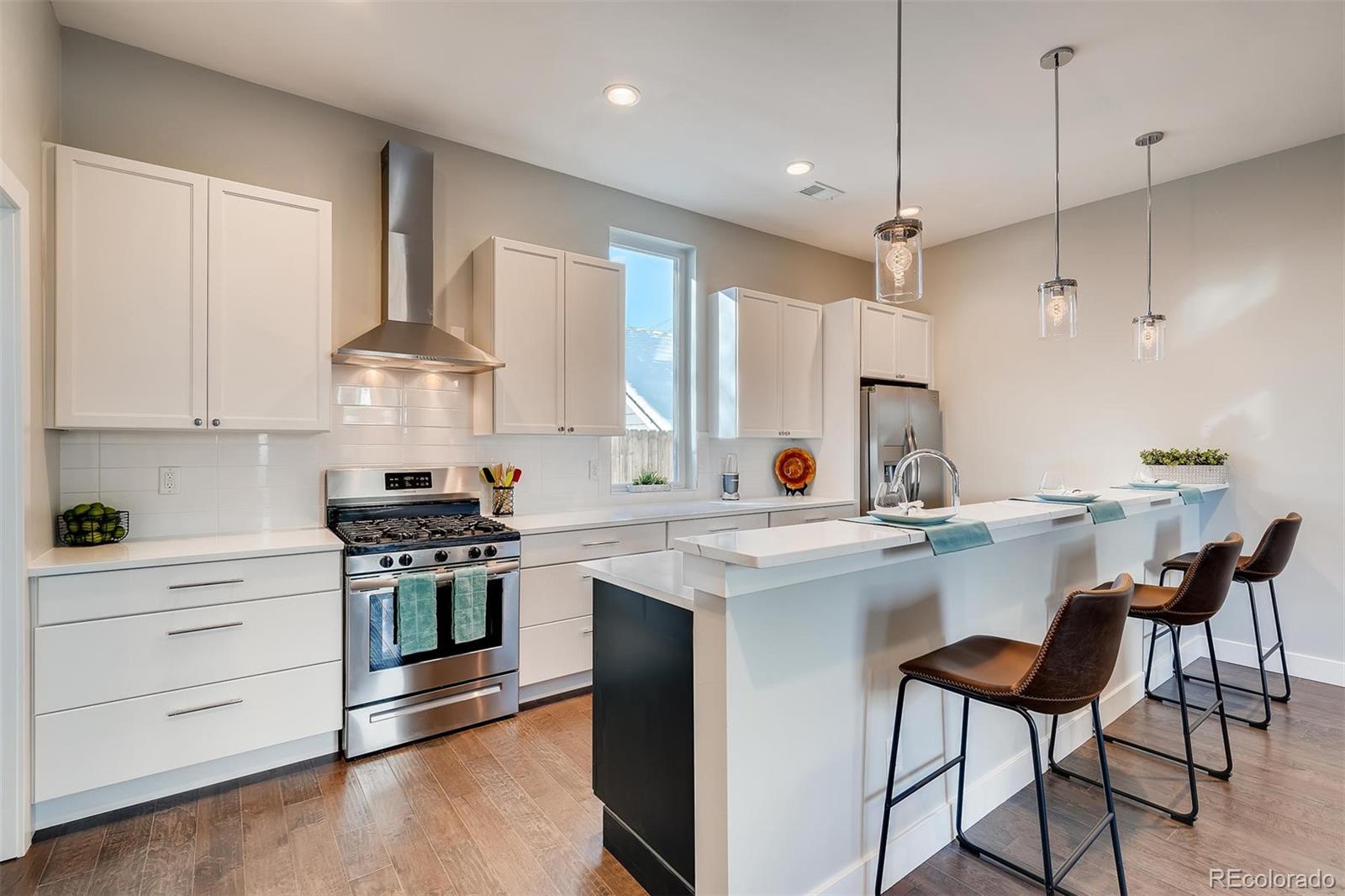 1237 Perry Street Denver, CO 80204 - Photo 6 of 37 a kitchen with stainless steel appliances a sink a stove and a refrigerator