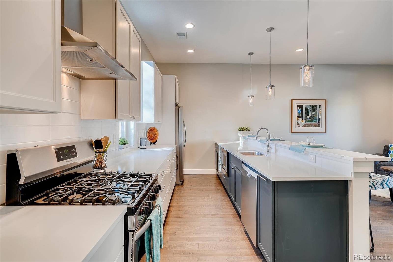 1237 Perry Street Denver, CO 80204 - Photo 7 of 37 a kitchen with sink stove and cabinets