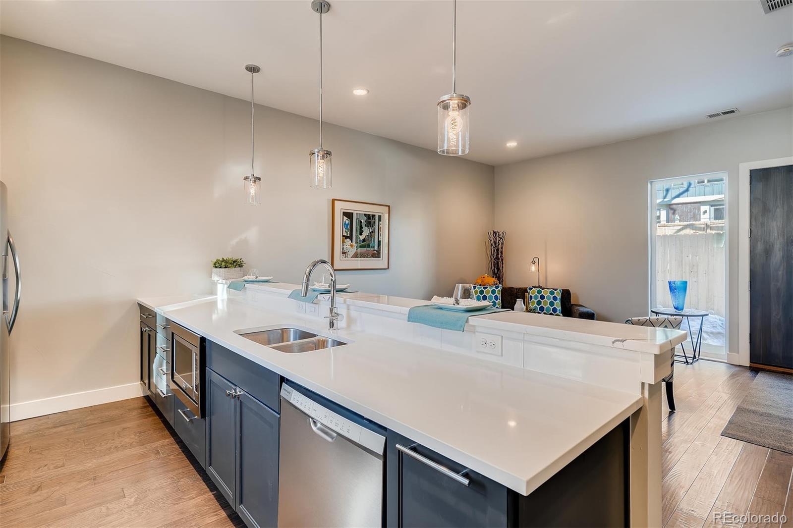 1237 Perry Street Denver, CO 80204 - Photo 8 of 37 a kitchen with a stove a refrigerator a sink dishwasher with a dining table and chairs