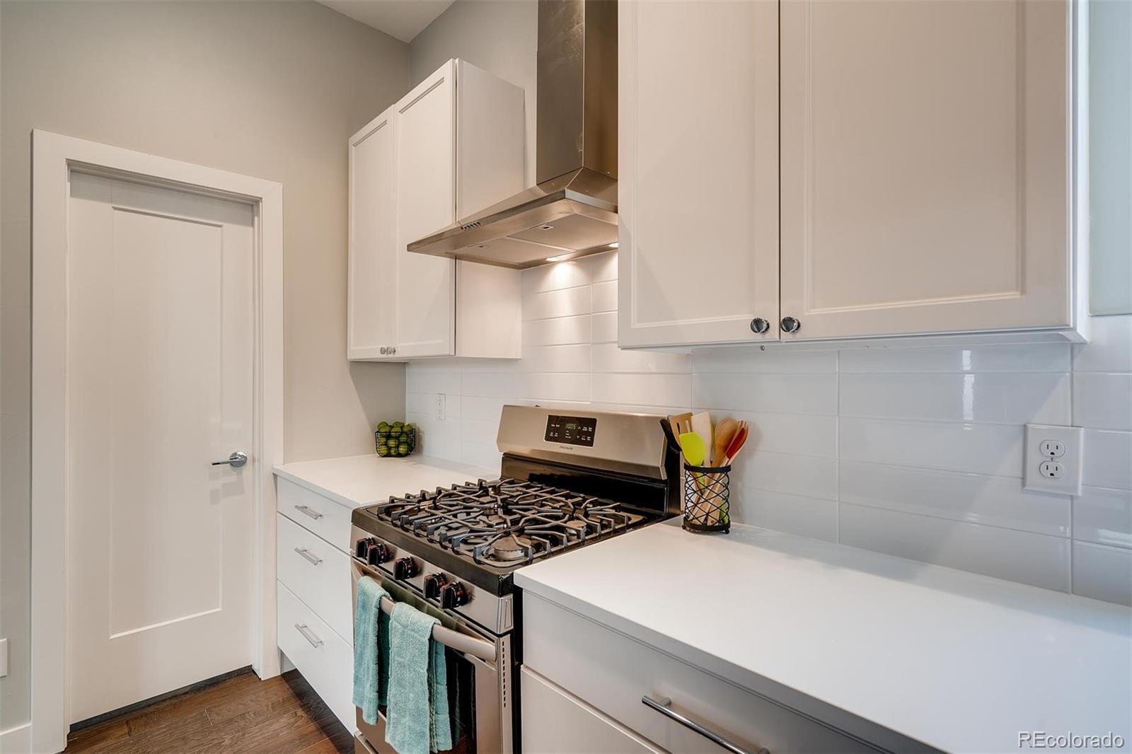 1237 Perry Street Denver, CO 80204 - Photo 9 of 37 a kitchen with a stove and white cabinets