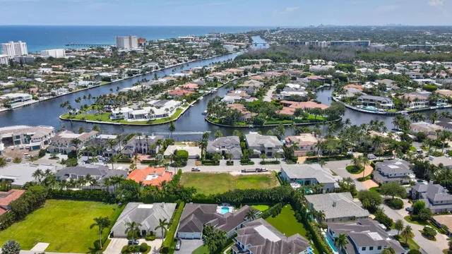 an aerial view of a city with lots of residential buildings lake and ocean view