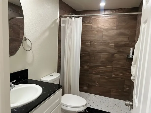 a white toilet sitting next to a bathroom sink