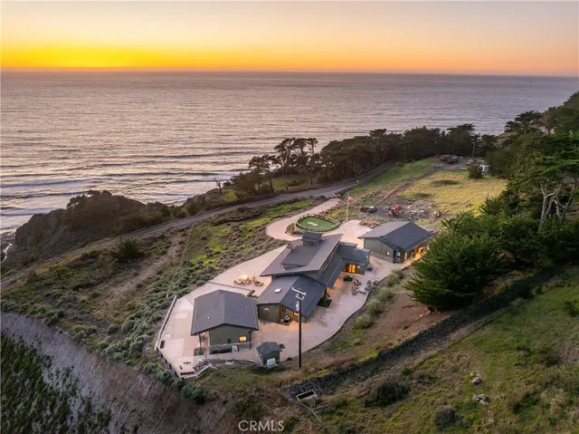 a kitchen with stainless steel appliances granite countertop a sink a stove and a wooden floors