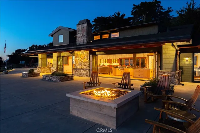 a living room with stainless steel appliances kitchen island granite countertop a sink and cabinets