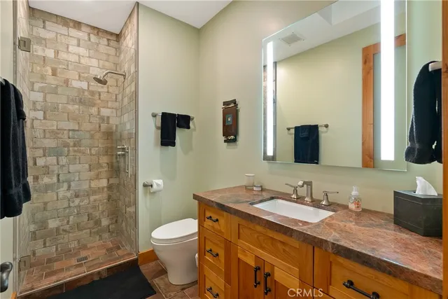 a dining hall with stainless steel appliances granite countertop a sink and a counter top space