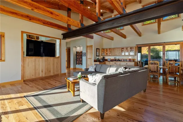 a living room with a fireplace furniture and a floor to ceiling window
