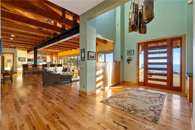 a view of a house with floor to ceiling windows and a flat screen tv