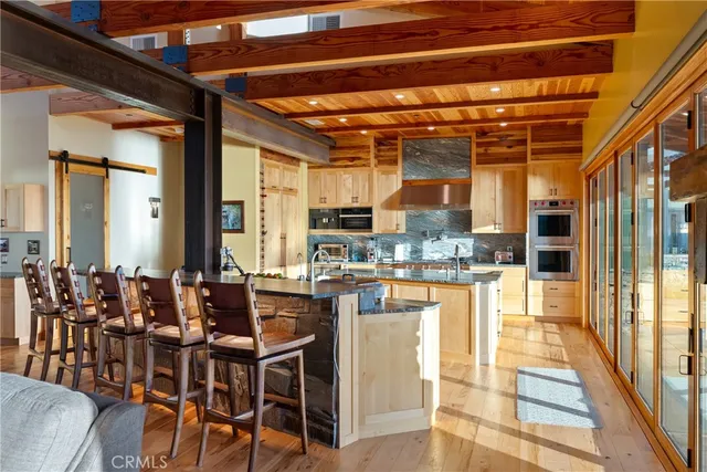 a kitchen with sink and view of living room