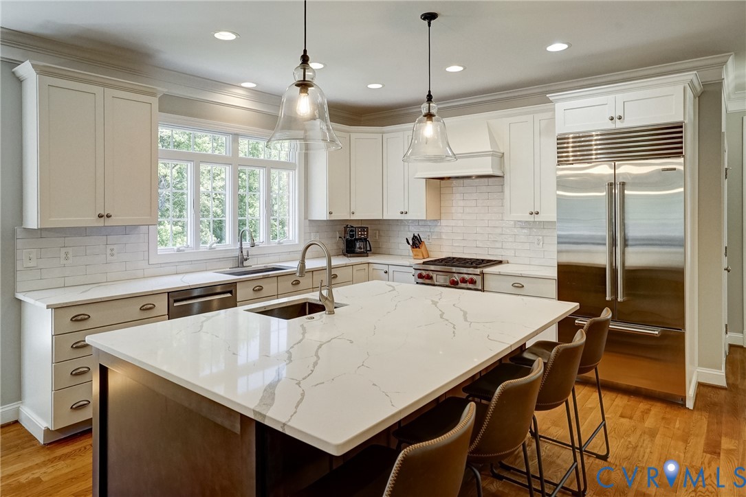 1295 Hermitage Road Manakin-Sabot, VA 23103 - Photo 26 of 55 a kitchen with granite countertop a sink a center island stainless steel appliances and windows