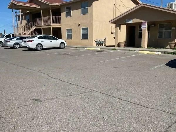 a couple of cars parked in front of a house