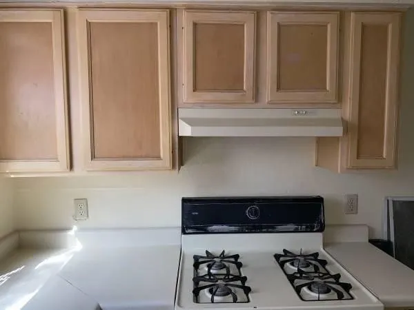 a white toilet sitting next to a bath tub and a shower