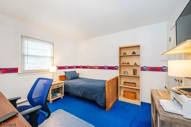 a bedroom with a bed and a workspace