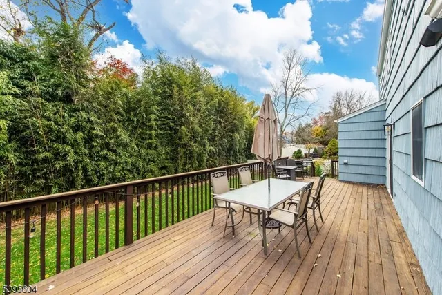a view of balcony with wooden floor and outdoor seating