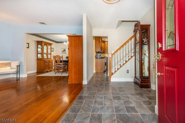 a view of a hallway with wooden floor and furniture