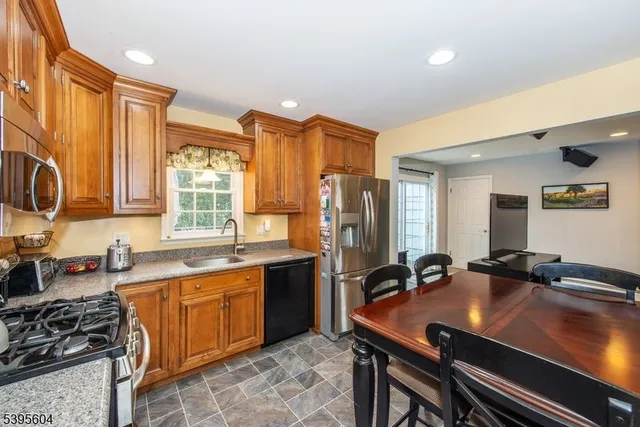 a kitchen with a sink appliances and cabinets