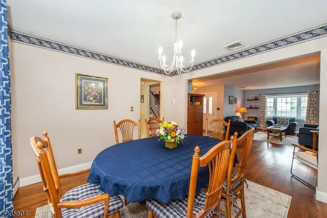 a view of a dining room with furniture and chandelier