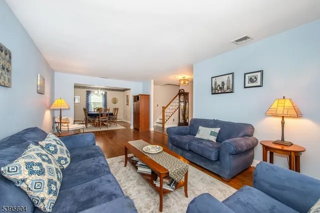 a living room with furniture and a lamp