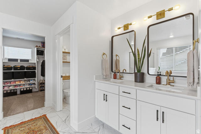596 South Meade Street Mapleton, UT 84664 - Photo 16 of 38 Full bathroom with healthy amount of natural light, a walk in closet, double vanity, and light marble finish floors