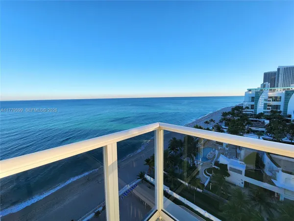 a view of a chairs and table in the balcony