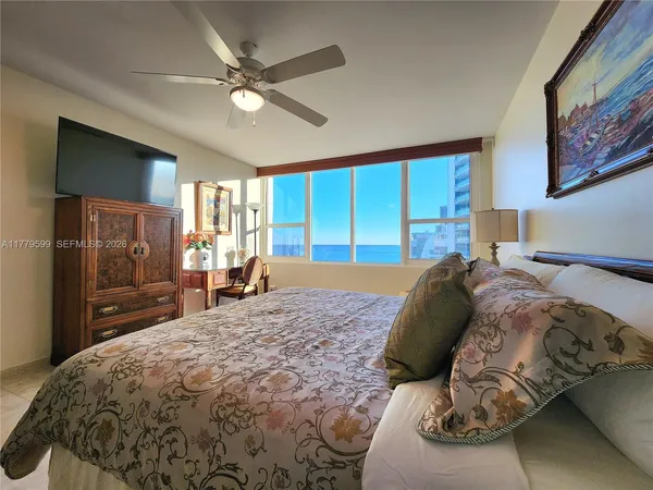 a bathroom with a bathtub shower sink and mirror