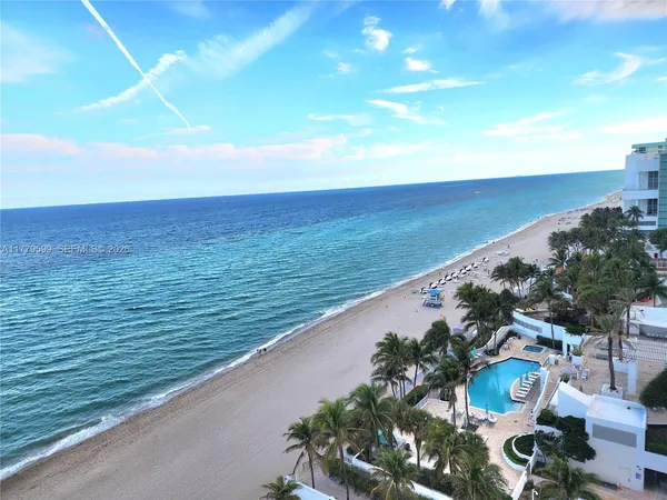 a living room with furniture pool table and a large window