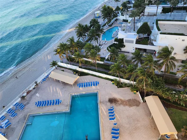 a living room with furniture a flat screen tv and a large window