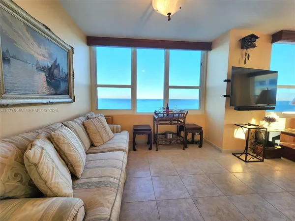 a bedroom with a large bed and a large window