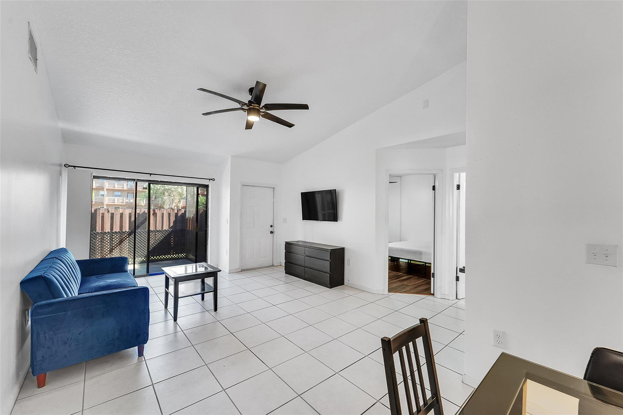 2698 North Nob Hill Road Sunrise, FL 33322 - Photo 4 of 27 a living room with furniture and a flat screen tv