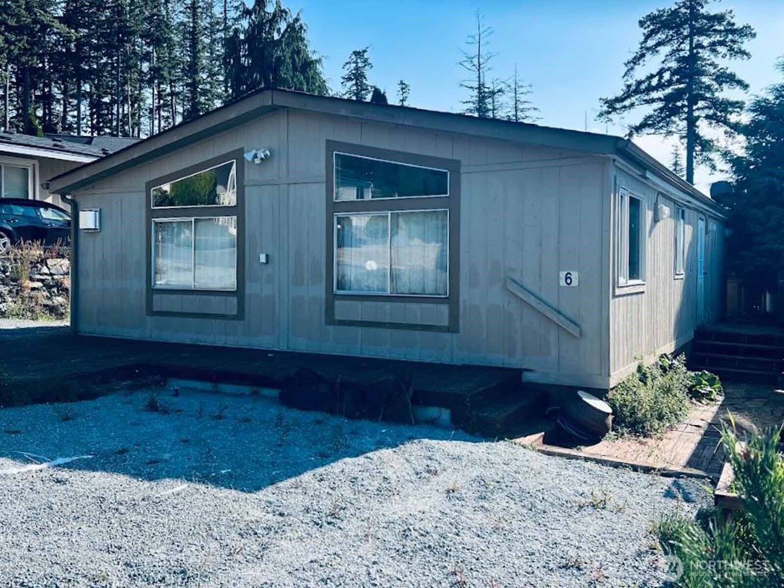 a view of house with backyard and trees