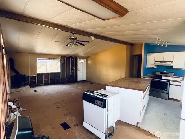 a kitchen with a stove a sink and a refrigerator
